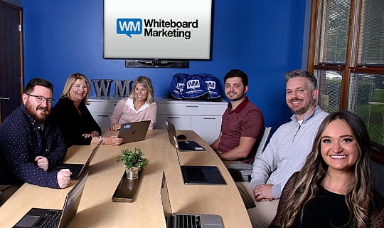 Whiteboard Marketing team in the conference room