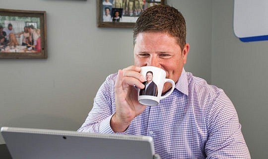 Sean White drinking coffee out of a mug with his face