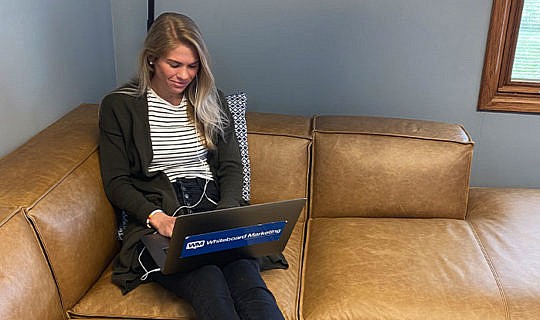 Account Manager working on comfy couch